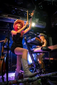 Mel Rocquette on stage with Boots On Country Rock